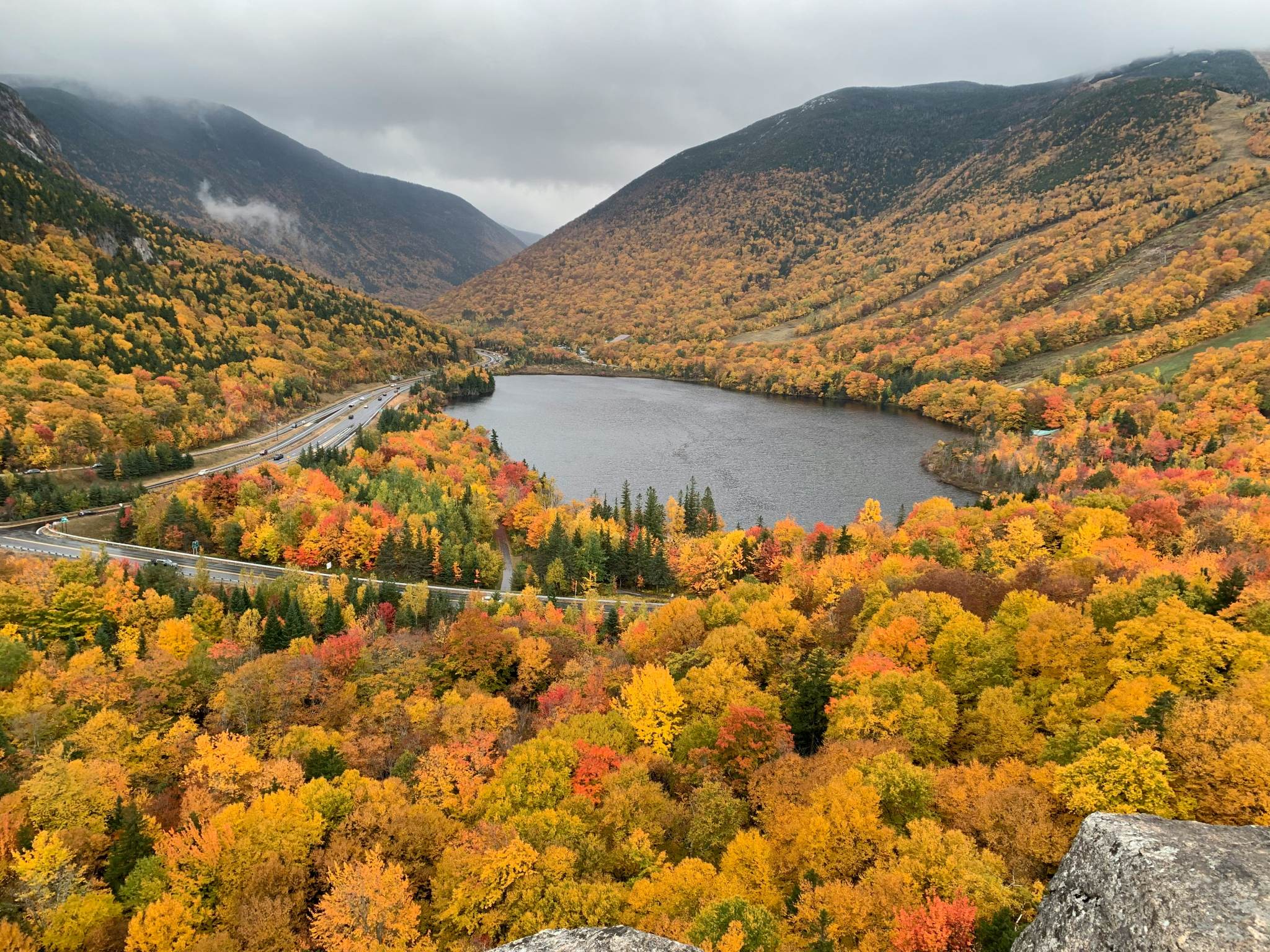 Fall foliage from the top of Artist Bluff looking at Cannon Mountain.