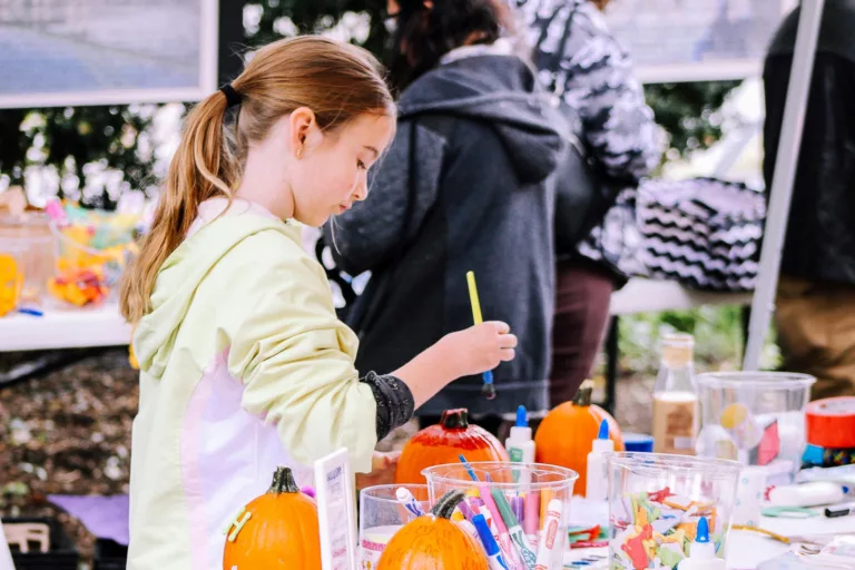 Kids painting pumpkins.